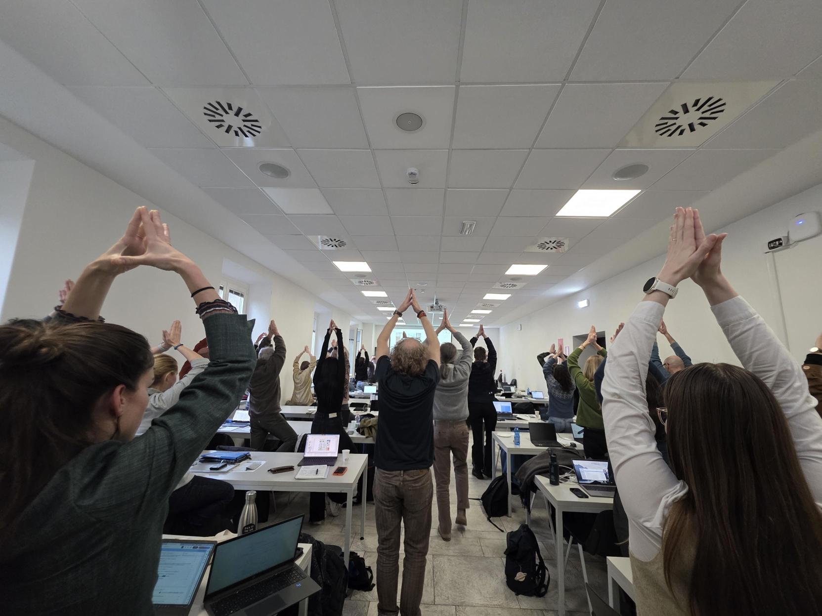 Partners doing yoga positions during a workshop.